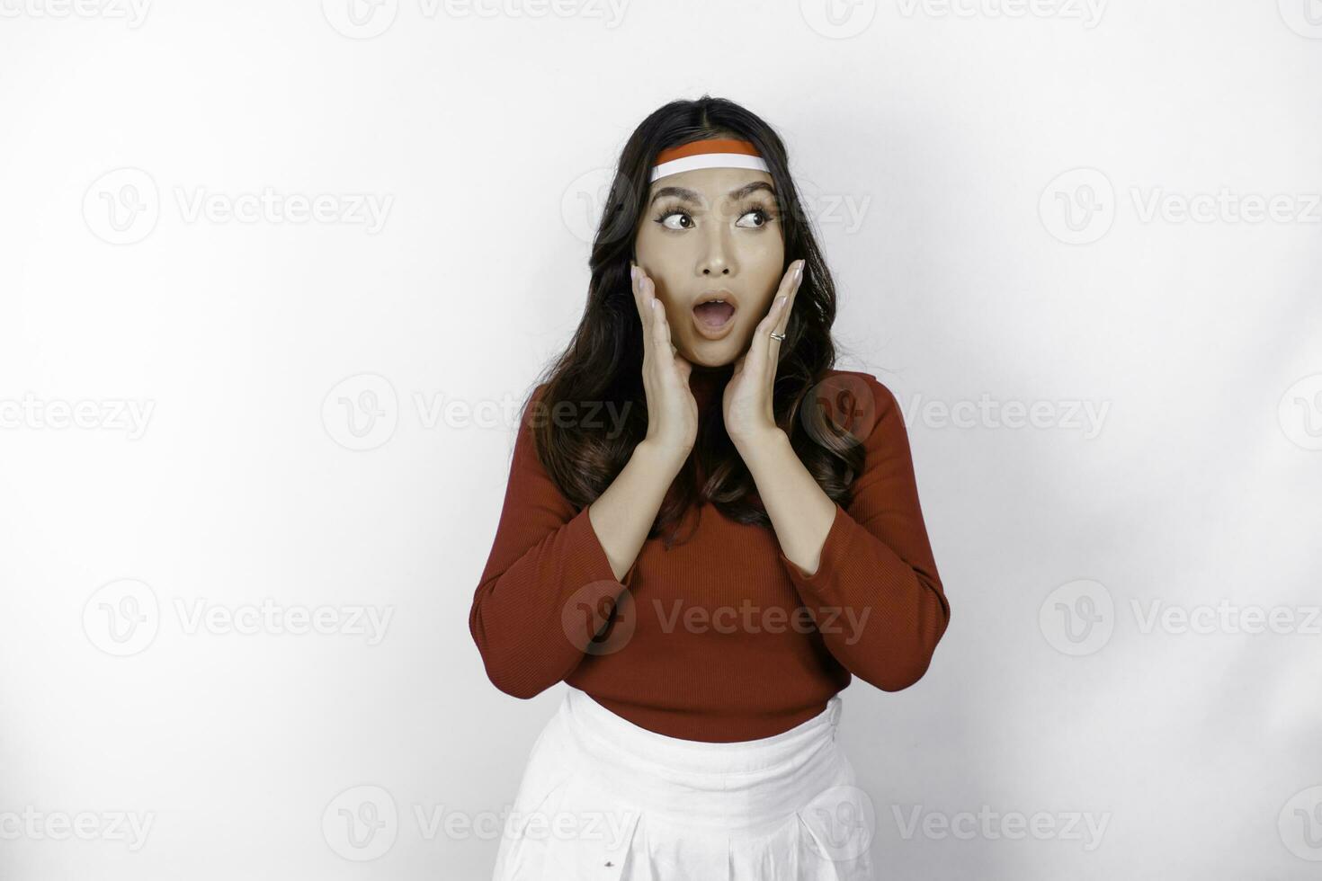 Shocked young Asian woman celebrate Indonesian independence day isolated on white background photo