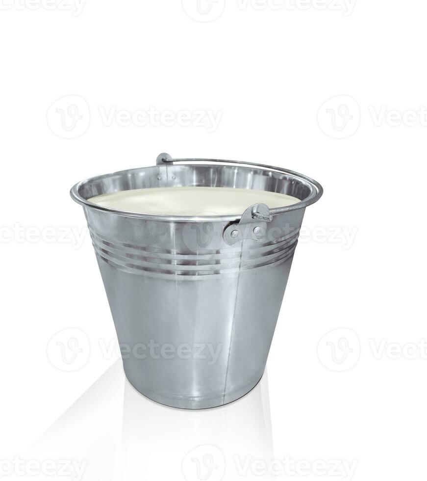 Milk in metal bucket isolated on white background photo