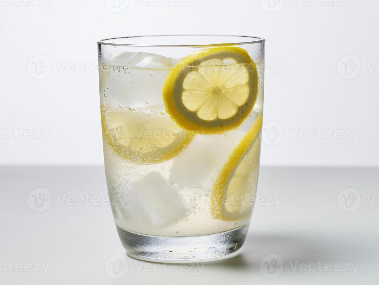 Refreshing glass of lemonade with ice cubes and lemon slices on white background - photo