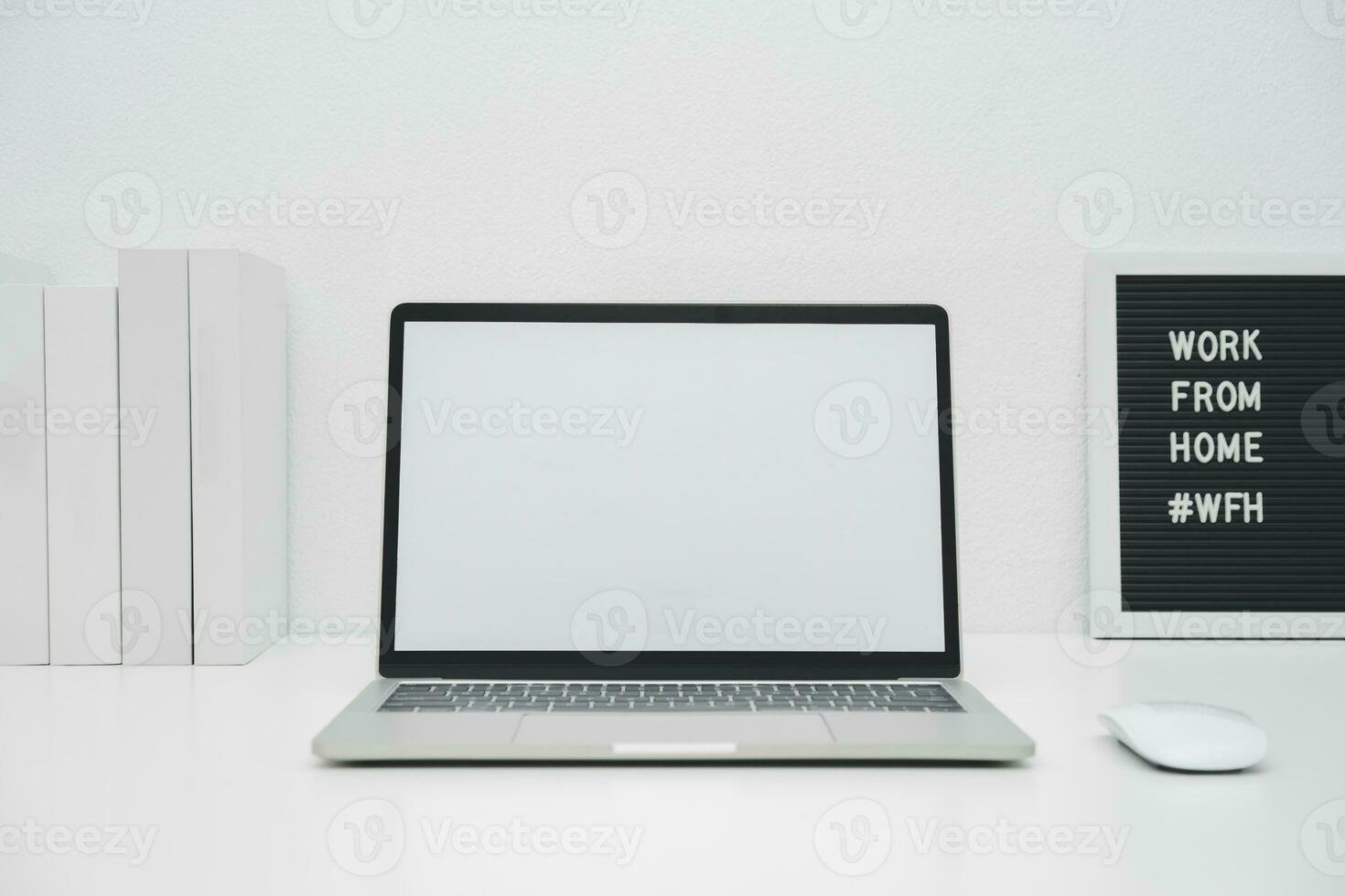 Minimalist laptop mockup white screen on white table with mouse. work from home concept photo