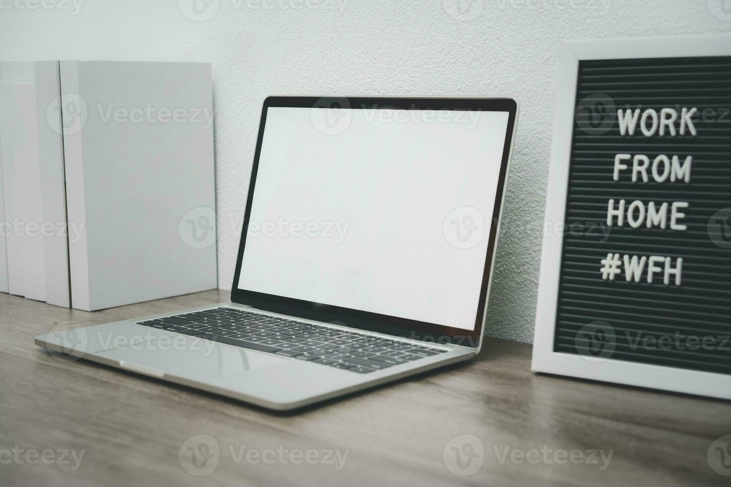 Minimalist laptop mockup white screen on white table with mouse. work from home concept photo