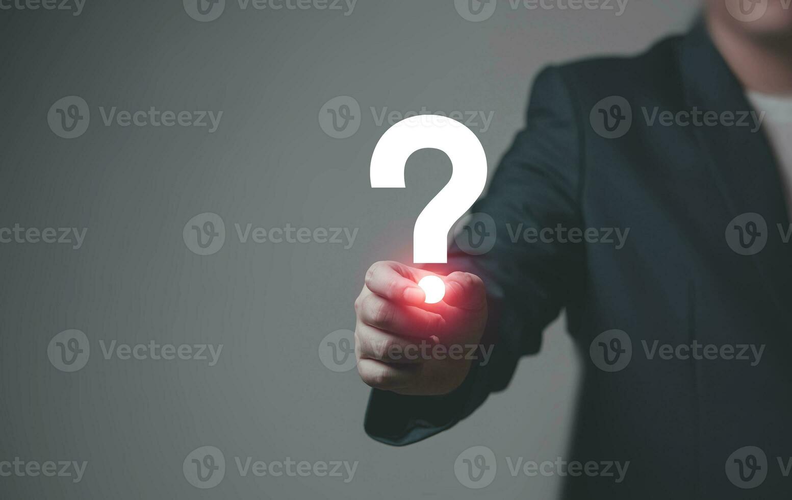 Businessman holding question mark. concept of Question mark and FAQs, Ask quiestion online, FAQ concept, what how and why, search information on internet. photo