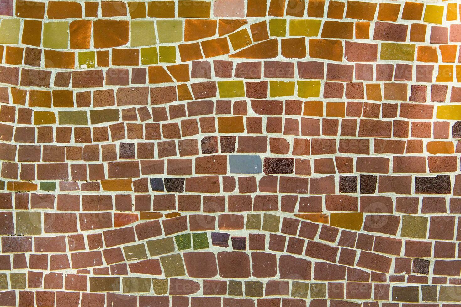 Colorful ceramic mosaic on the walls of the building. Abstract background and texture for design. photo