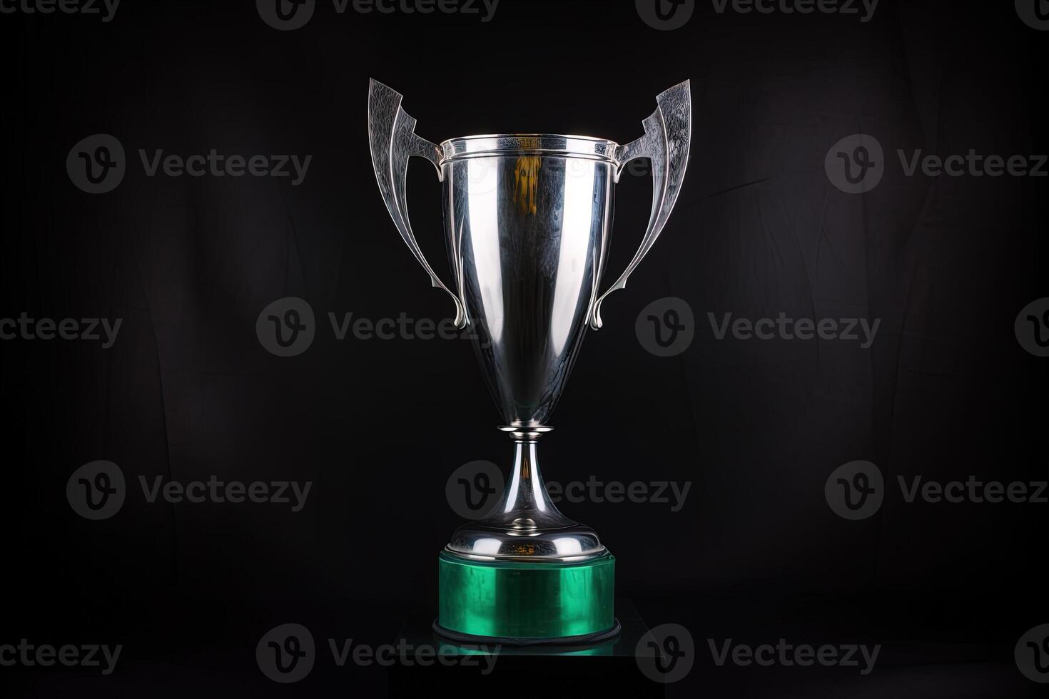 Silver glowing trophy cup on dark background. Concept of success and achievement photo