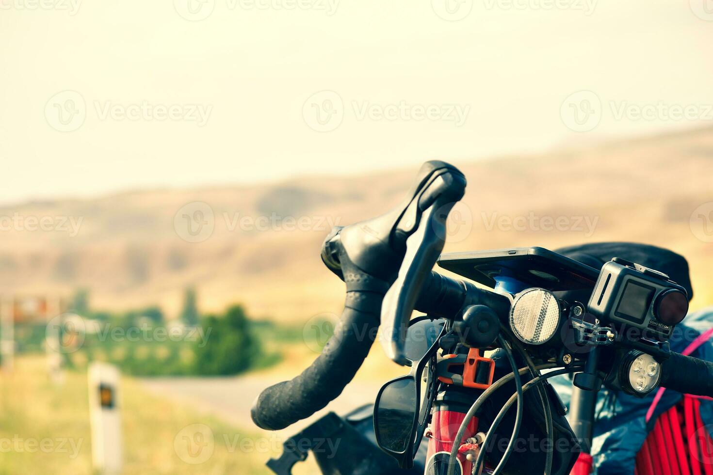 Drop bar touring bicycle stand close up with action camera attached to frame .Bicycle touring outdoors in nature photo