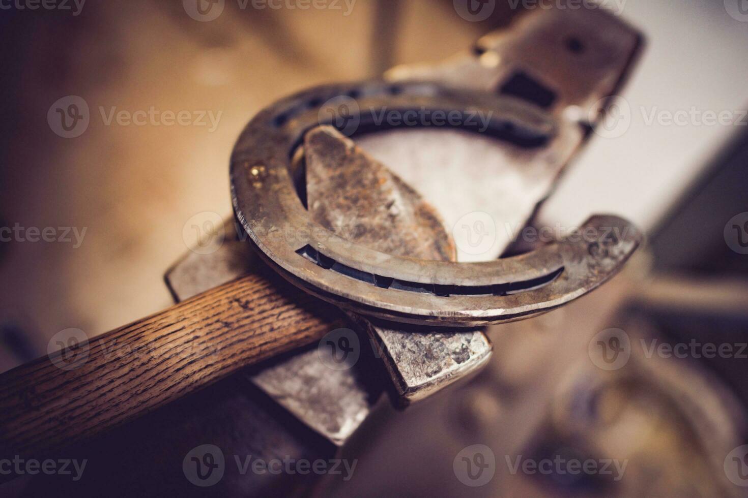 Hammer, anvil and horseshoe. Tools of blacksmith. Equestrian theme. photo