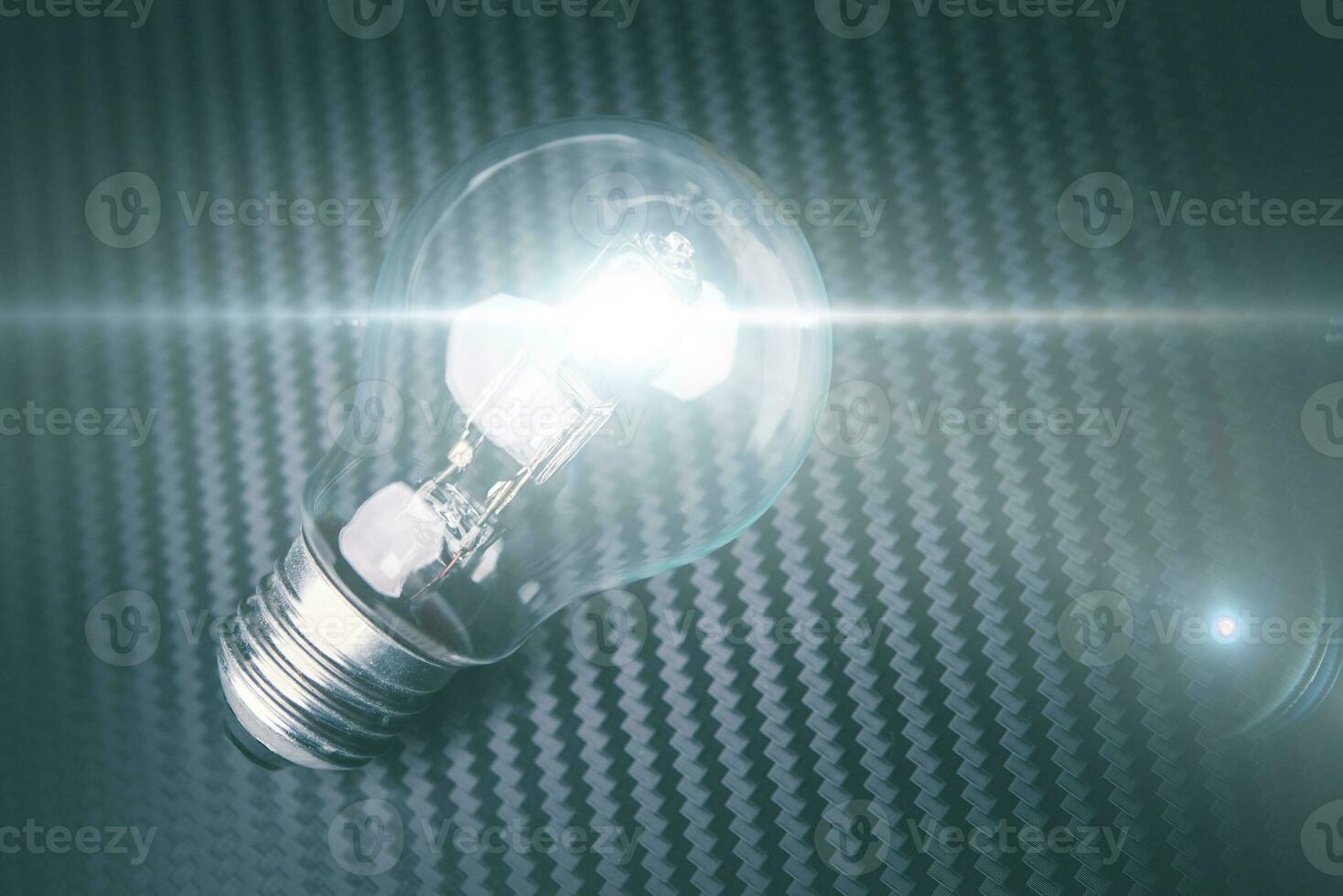 Self illuminating bulb on carbon background. Technology idea concept. photo