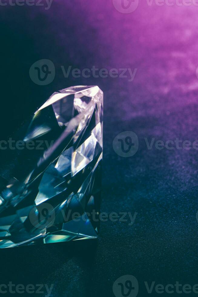 Real diamond stone on dark background. Diamond jewelry theme. photo