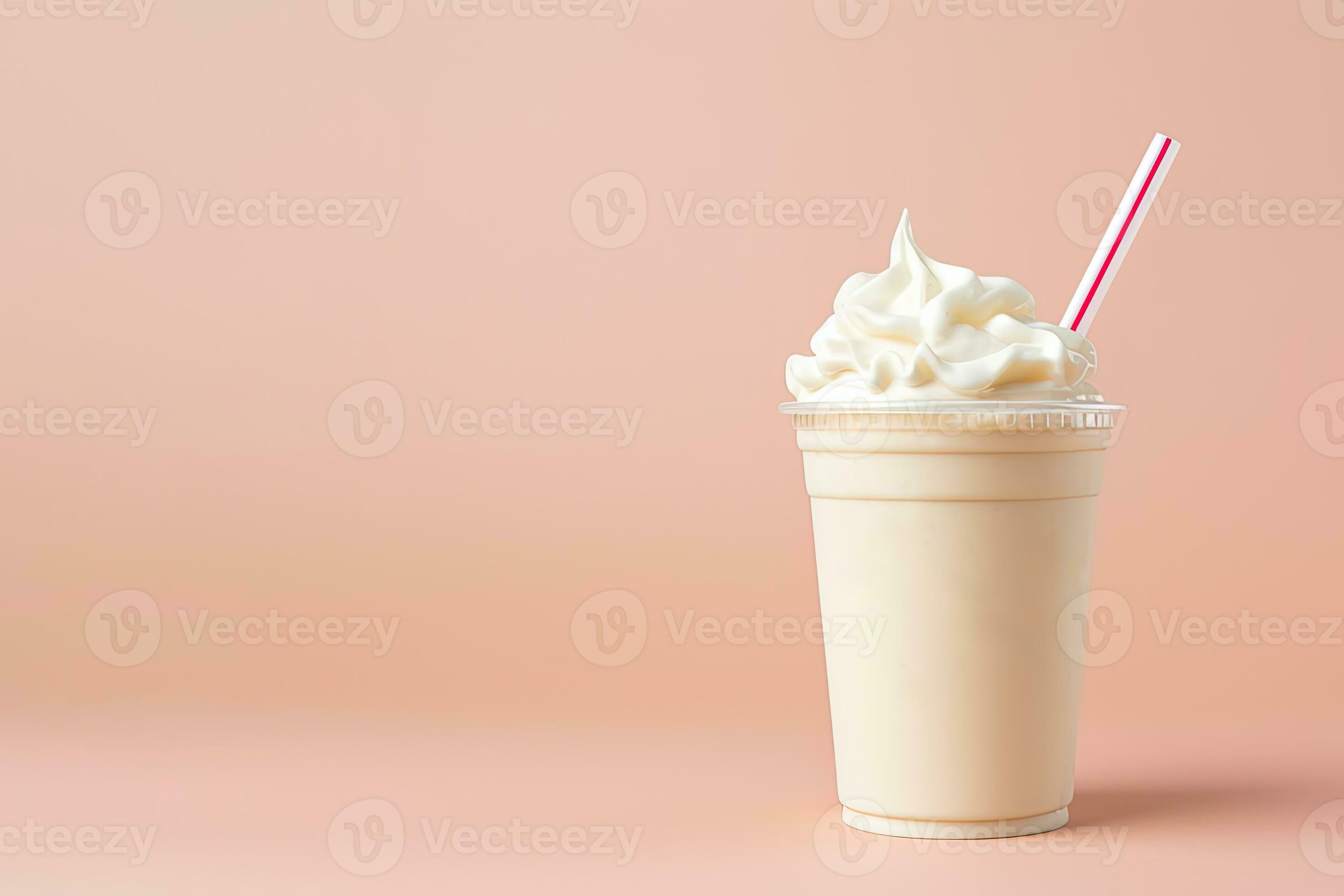 Vanilla milkshake in plastic takeaway cup isolated on white