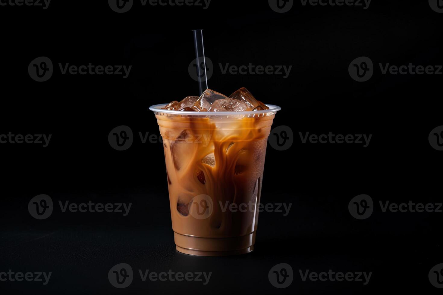 Iced coffee in plastic take-away glass isolated on dark background. photo