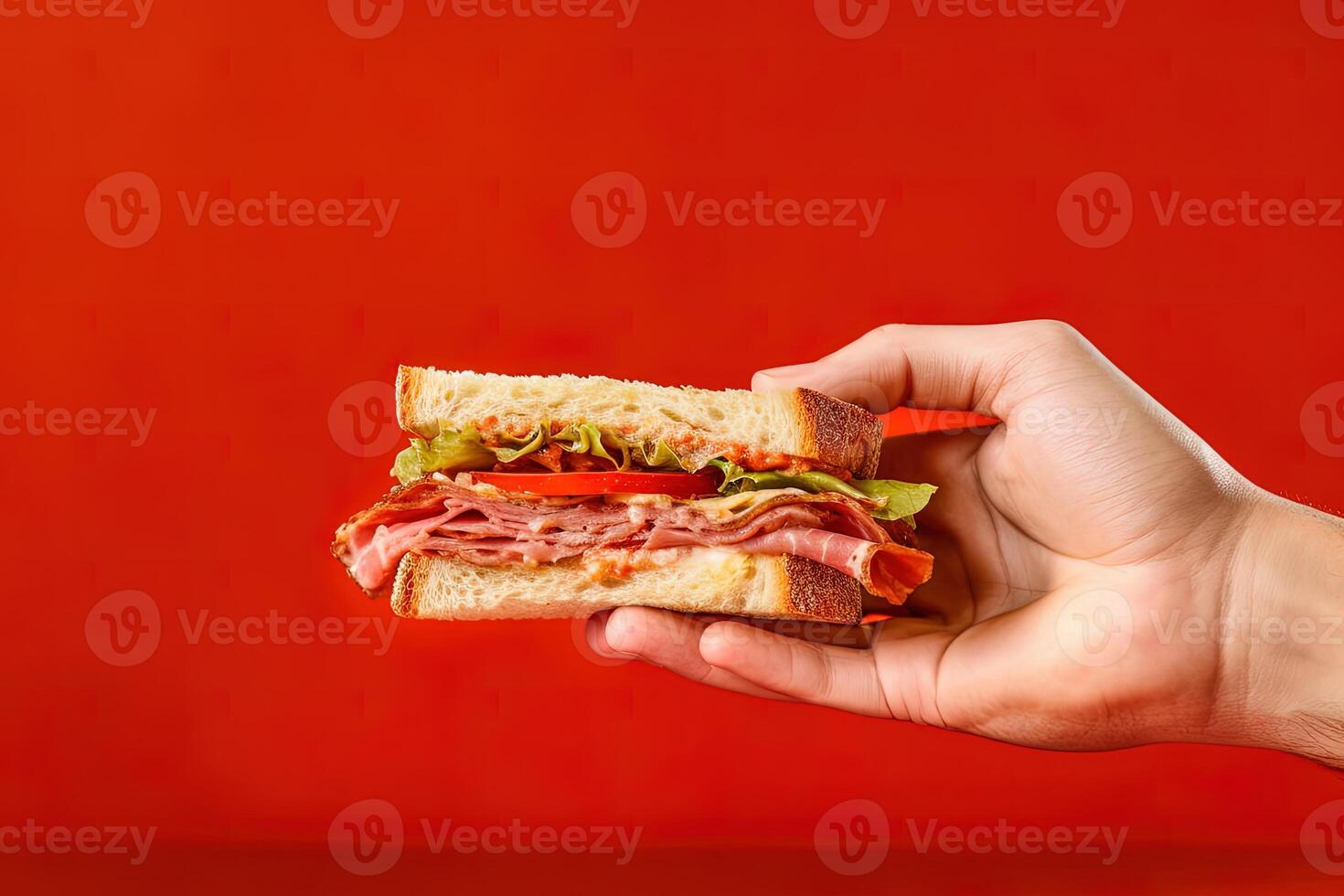 Hand holding tasty sandwich on a red background. ai generated photo