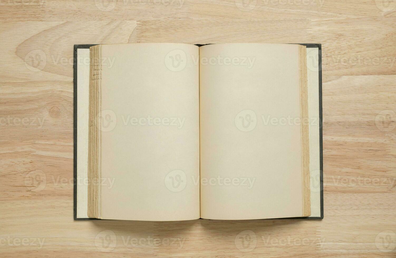 open old book on wooden table for mockup blank template photo