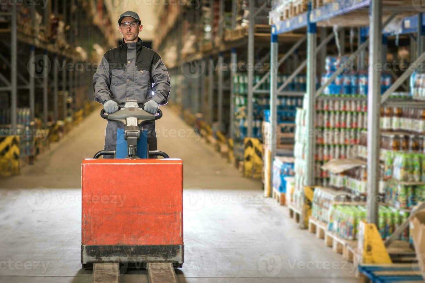 Caucasian Worker in uniform with pallet jack photo