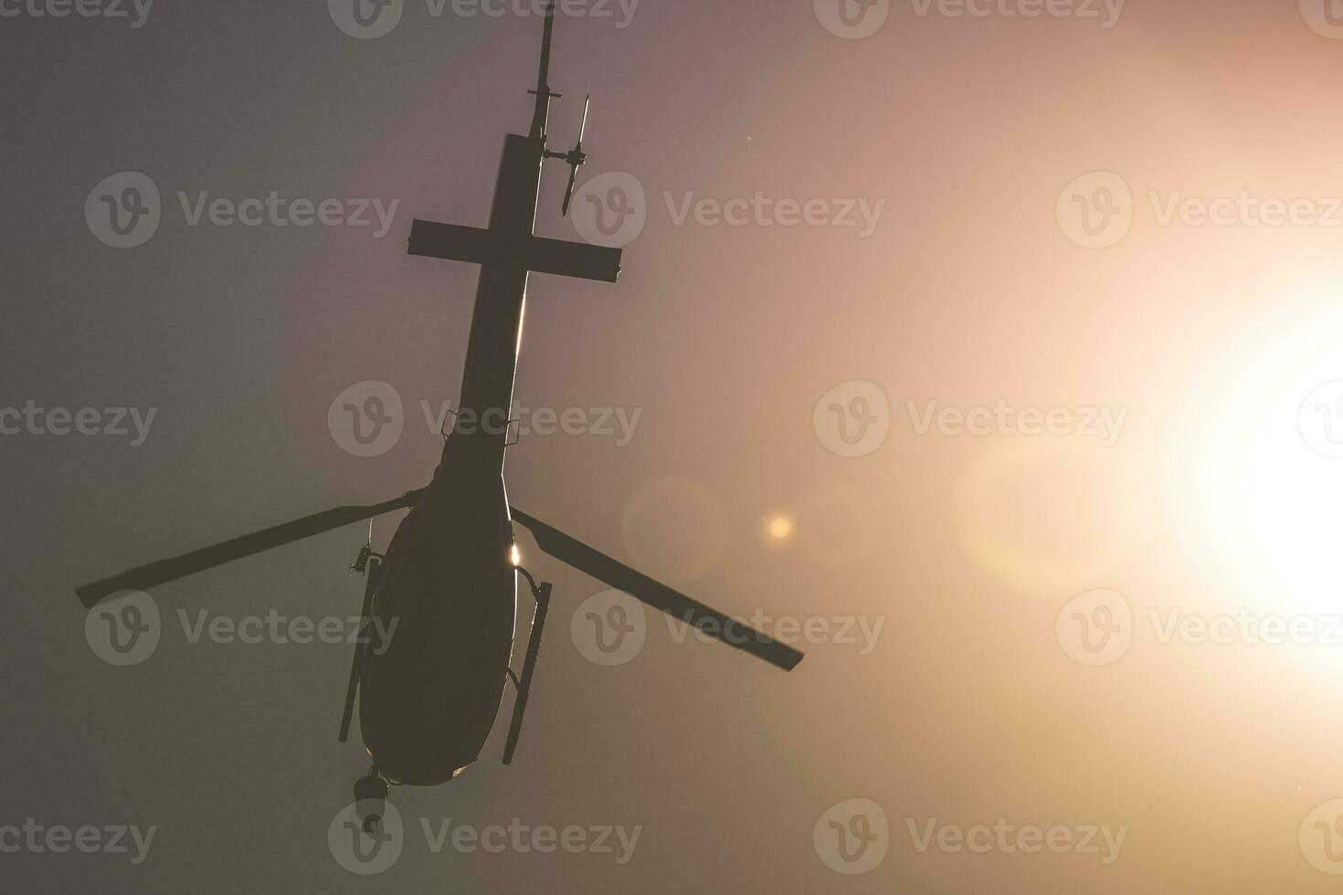 Helicopter in the Air with Sunlit Sky Background photo