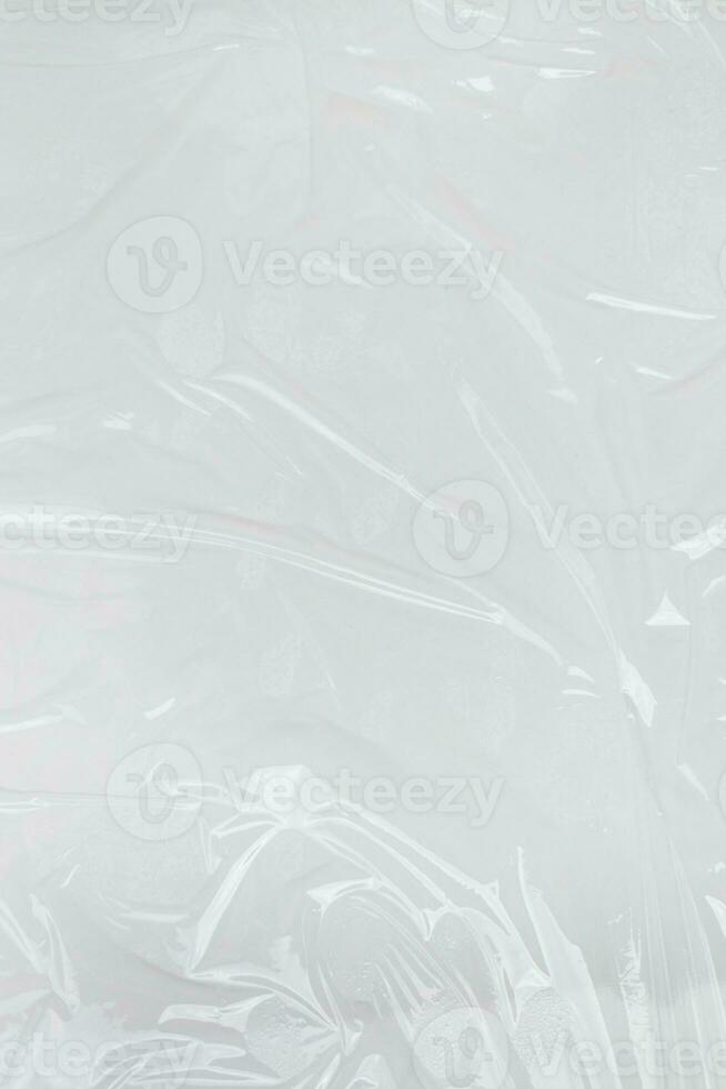 Vertical transparant wrinkled plastic, white plastic or polyethylene bag texture, macro, white background photo