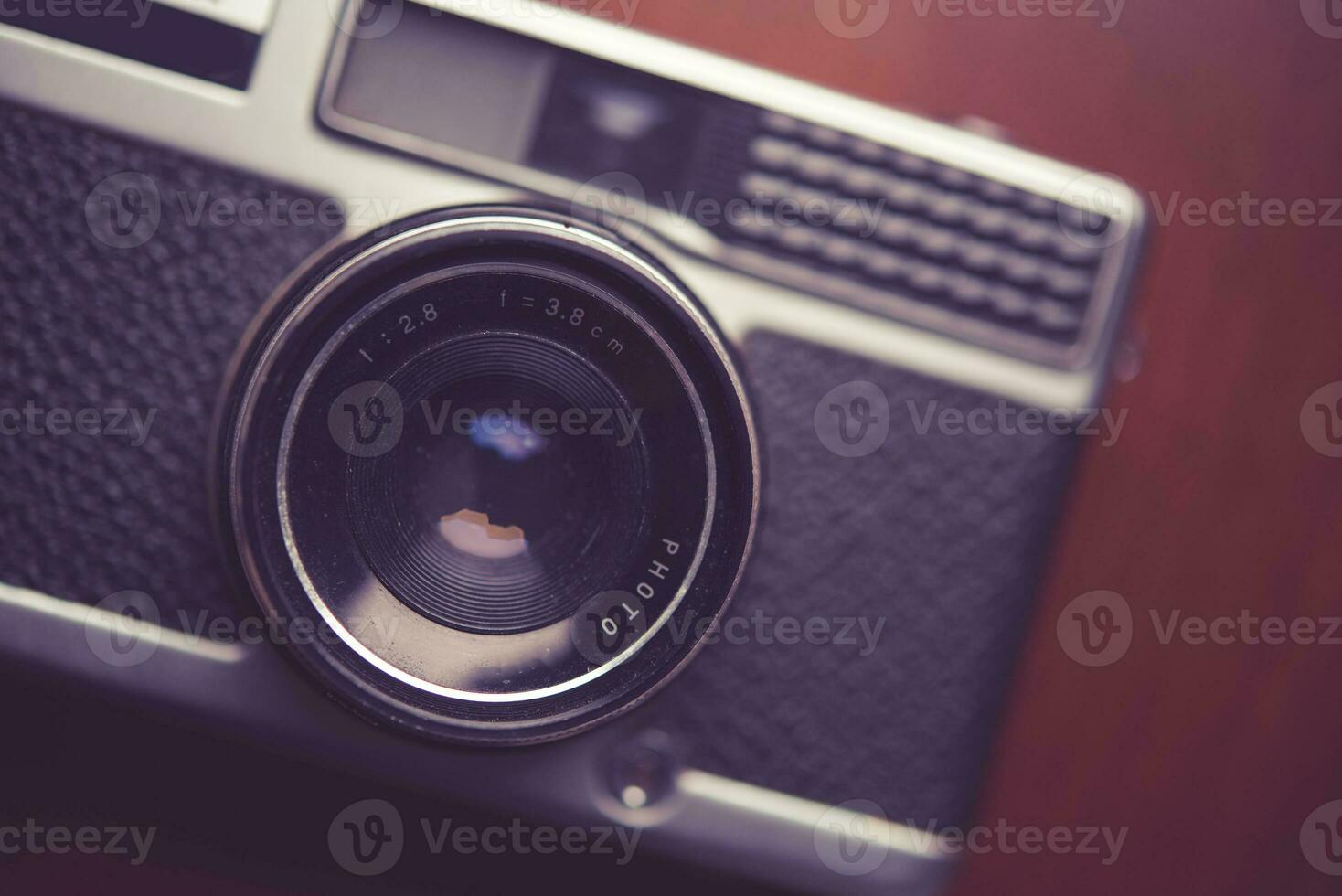Retro camera on wood table background photo