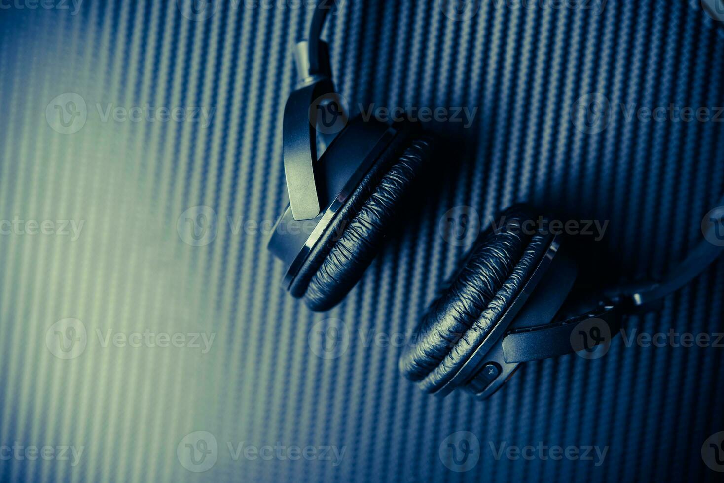 Wireless headphones on carbon background. photo