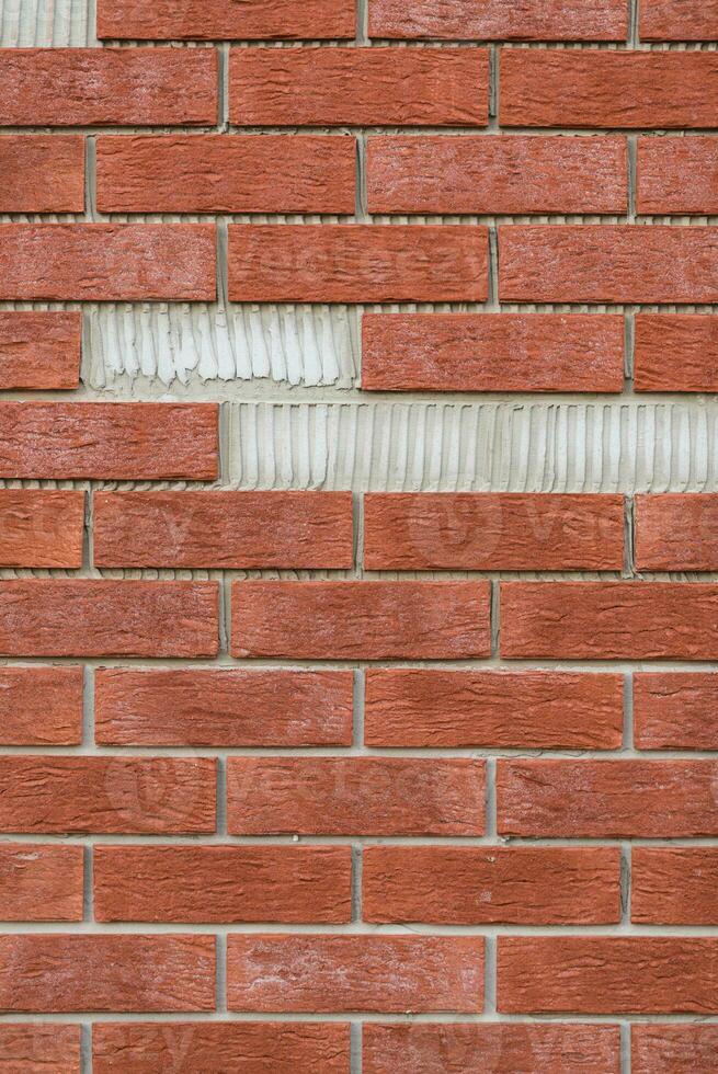 Brick wall with missing parts. photo