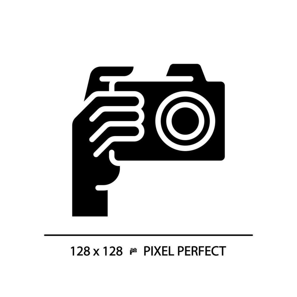 Hand with camera pixel perfect black glyph icon. Person taking shot with analog equipment. Photographer tool. Silhouette symbol on white space. Solid pictogram. Vector isolated illustration