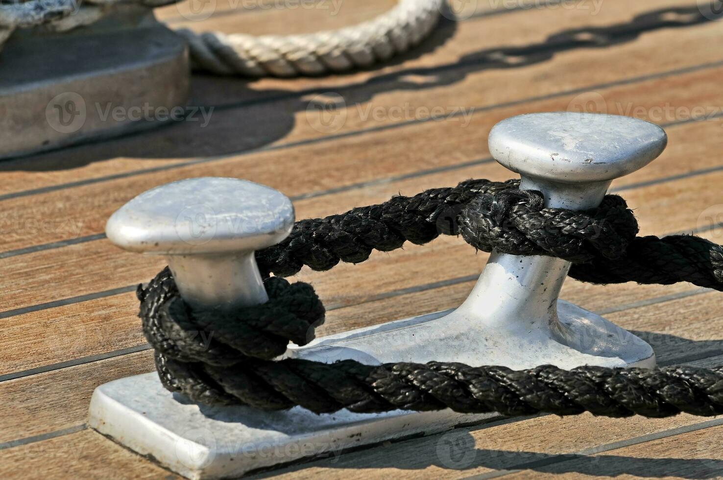 Moored boat - Cleat with rope photo