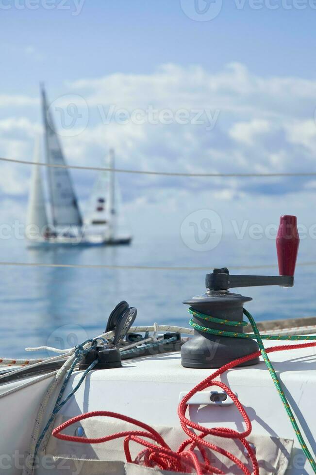 Sailing - Close-up of Winch with Sailboat in Background photo