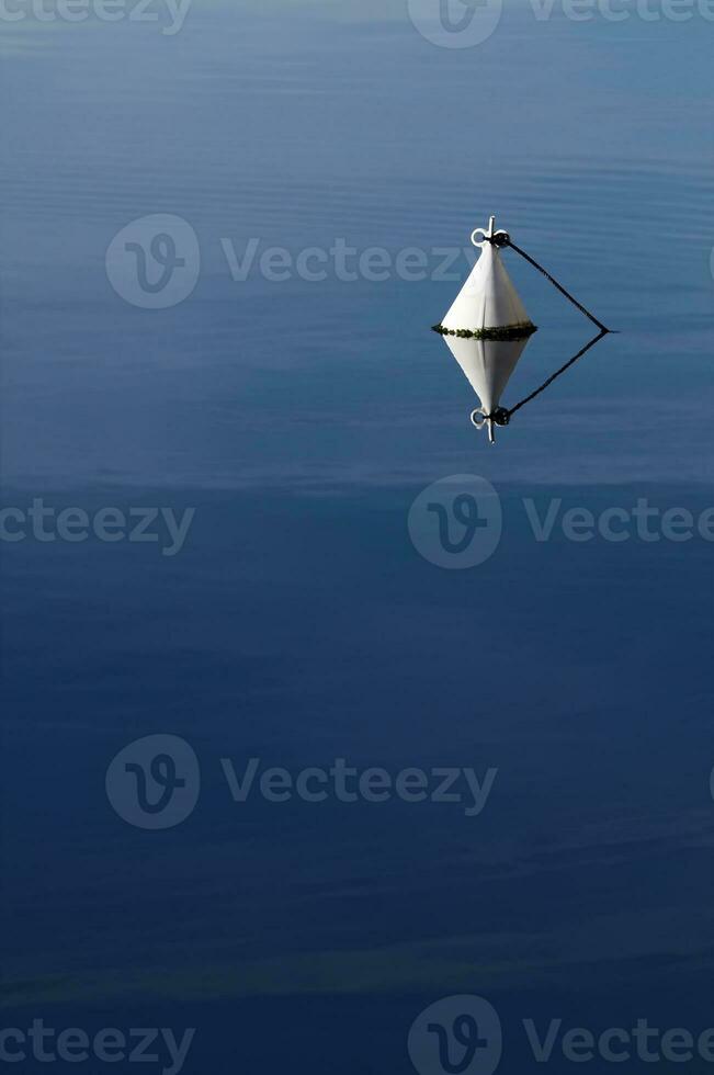 Buoy in a Calm Blue Water photo