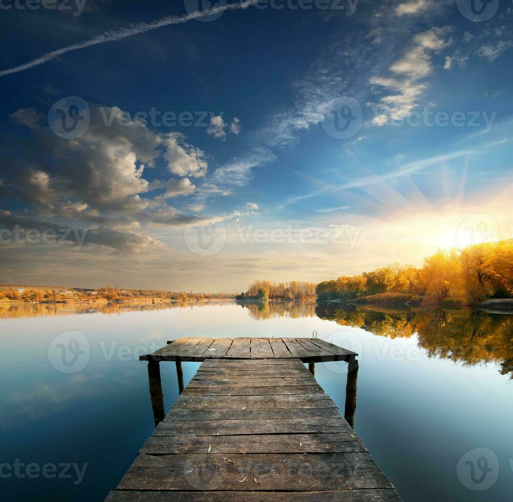Pier on a calm river photo