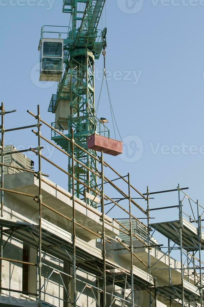 Contruction Site with Scaffolding and Crane photo