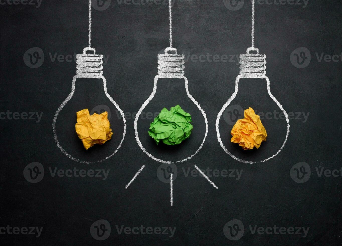 Crumpled sheets of paper inside drawn chalk lamps. Concept of searching for new ideas photo