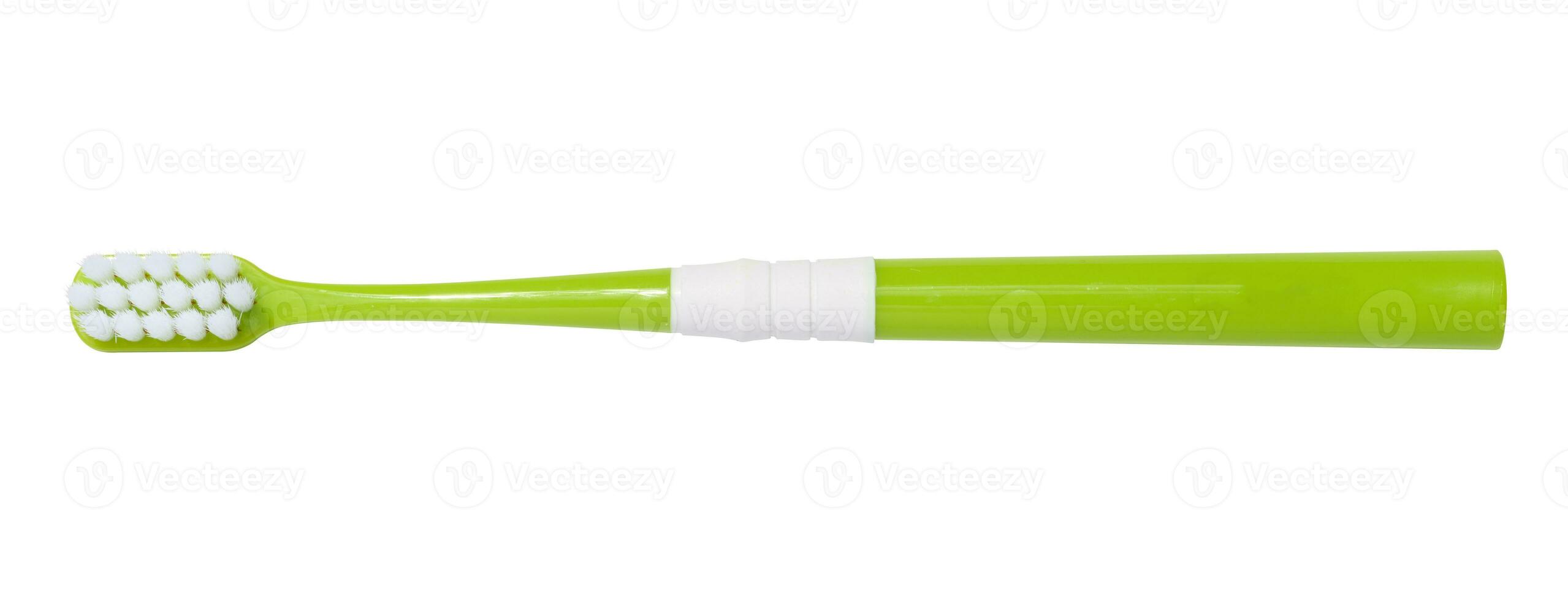 Green plastic toothbrush isolated on white background, top view photo