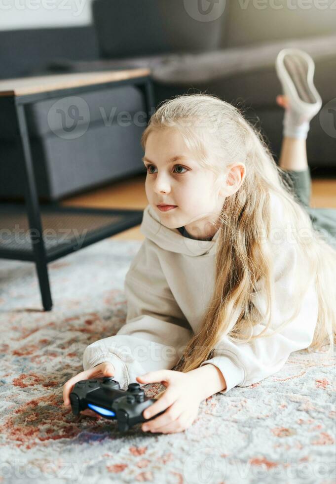 Girl playing video game at home photo