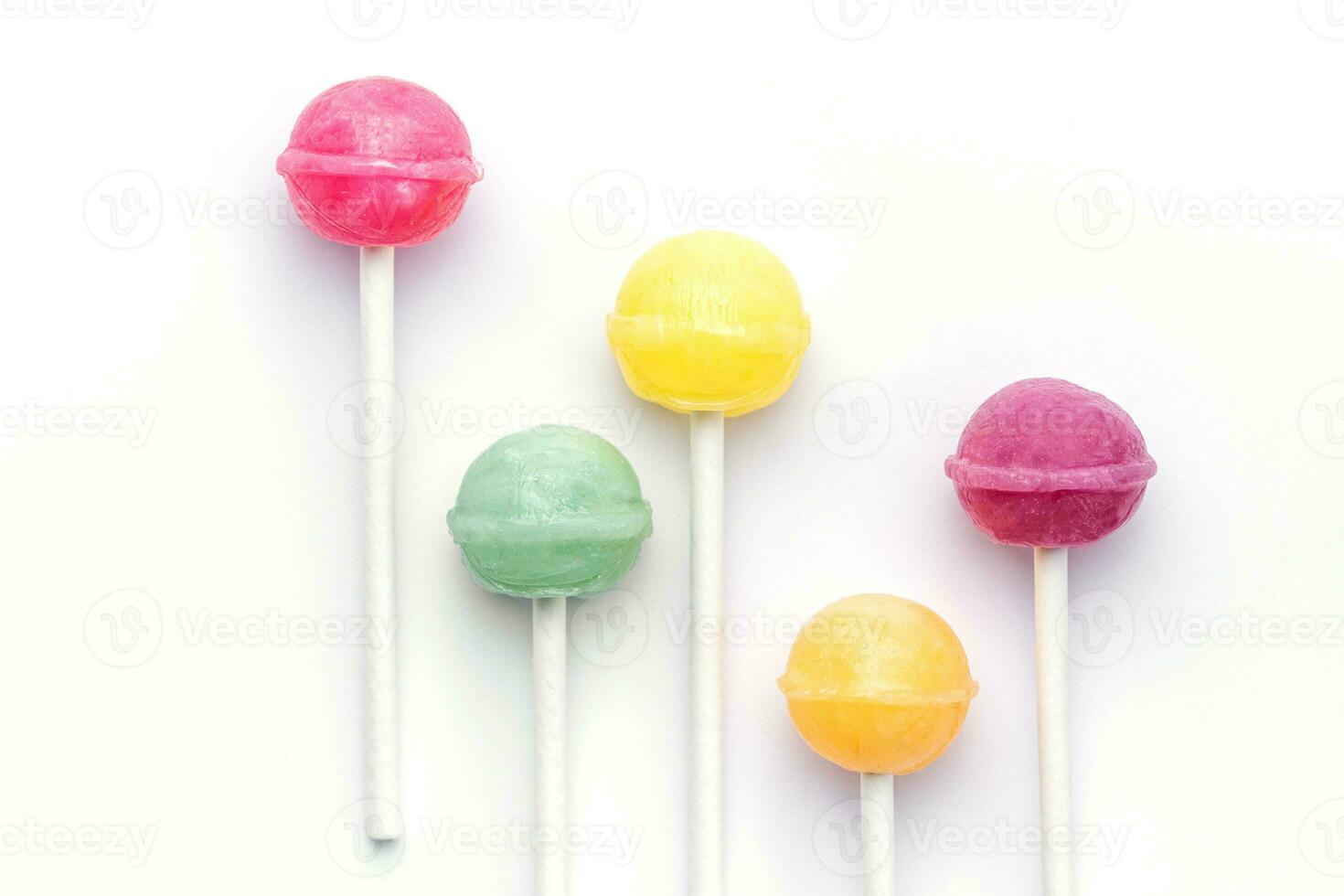 Sweet lollipops on white background photo