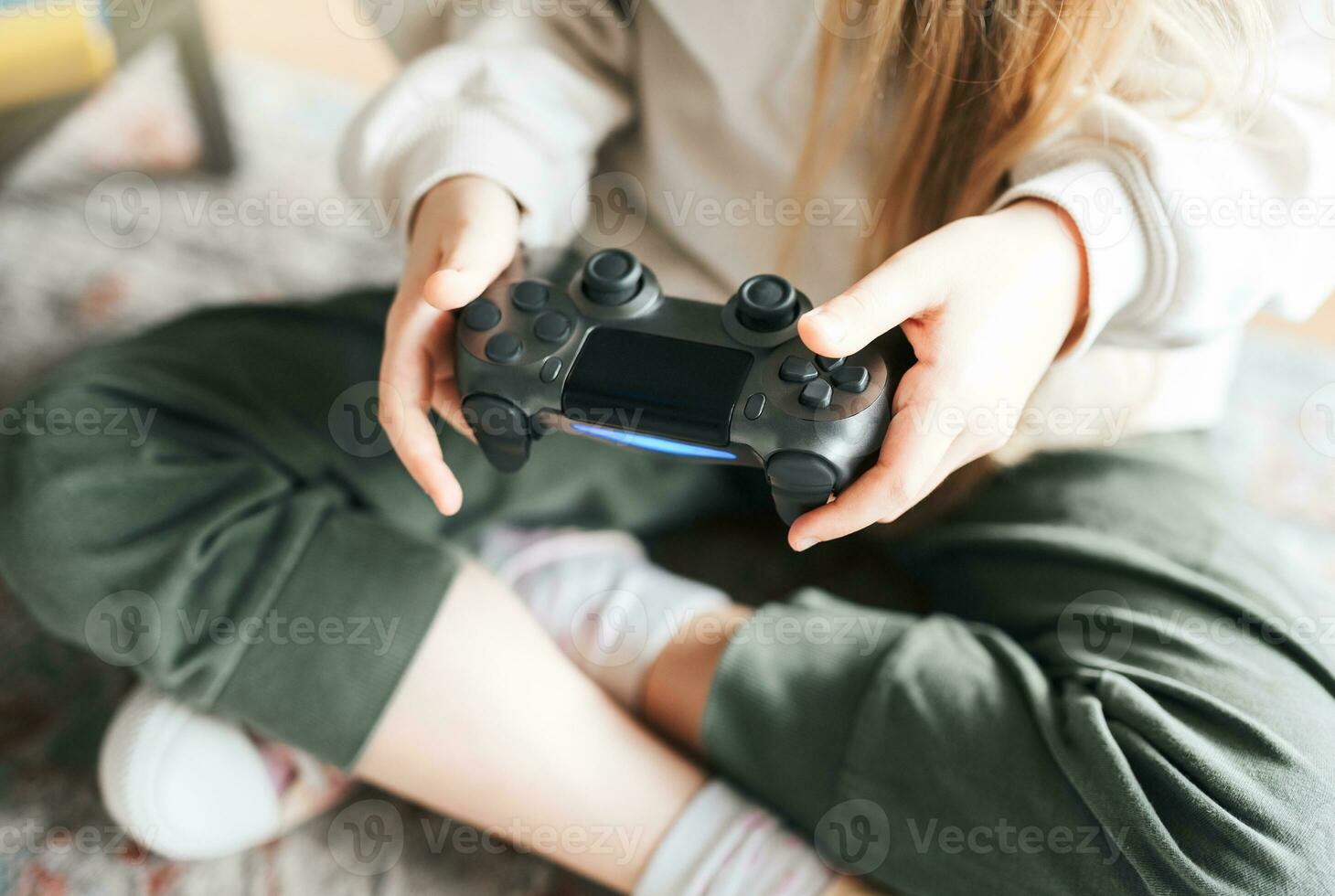 Little girl playing on games console photo