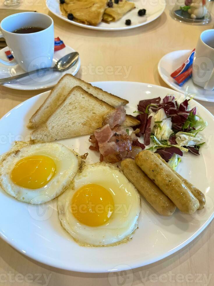 English breakfast fried eggs with sausages and salad photo