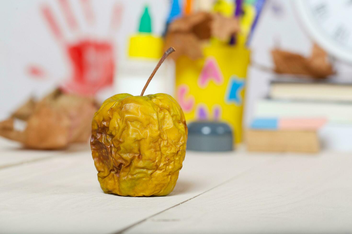 Dehydrated green apple on a wooden surface photo