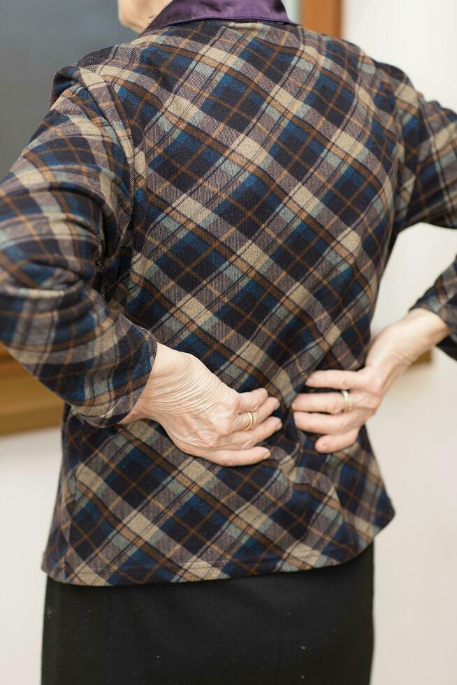 Old woman has backache. photo
