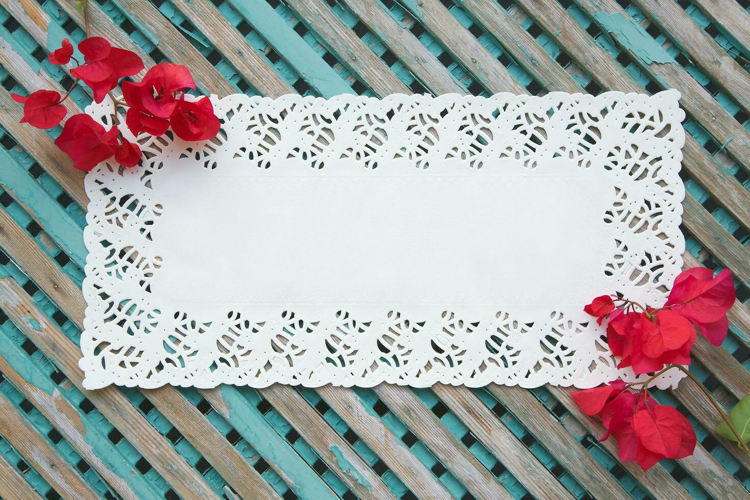 Decorative lace napkin on an old wooden surface photo