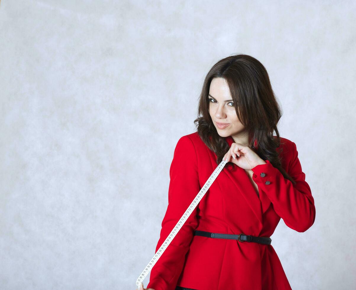 A young woman and a measuring band photo