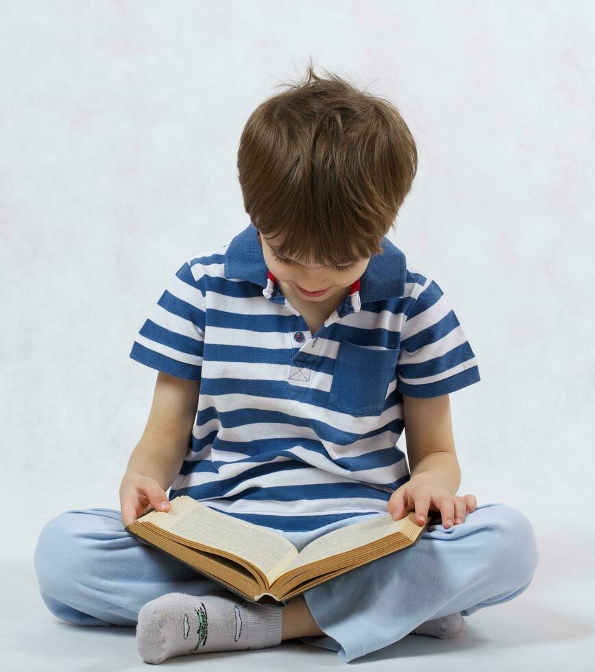 A boy is reading a book on a white background photo