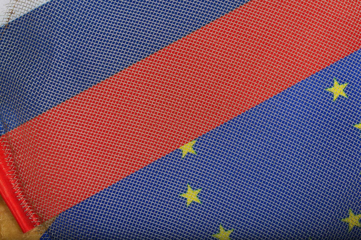 Metallic net on two flags -EU and Russia photo