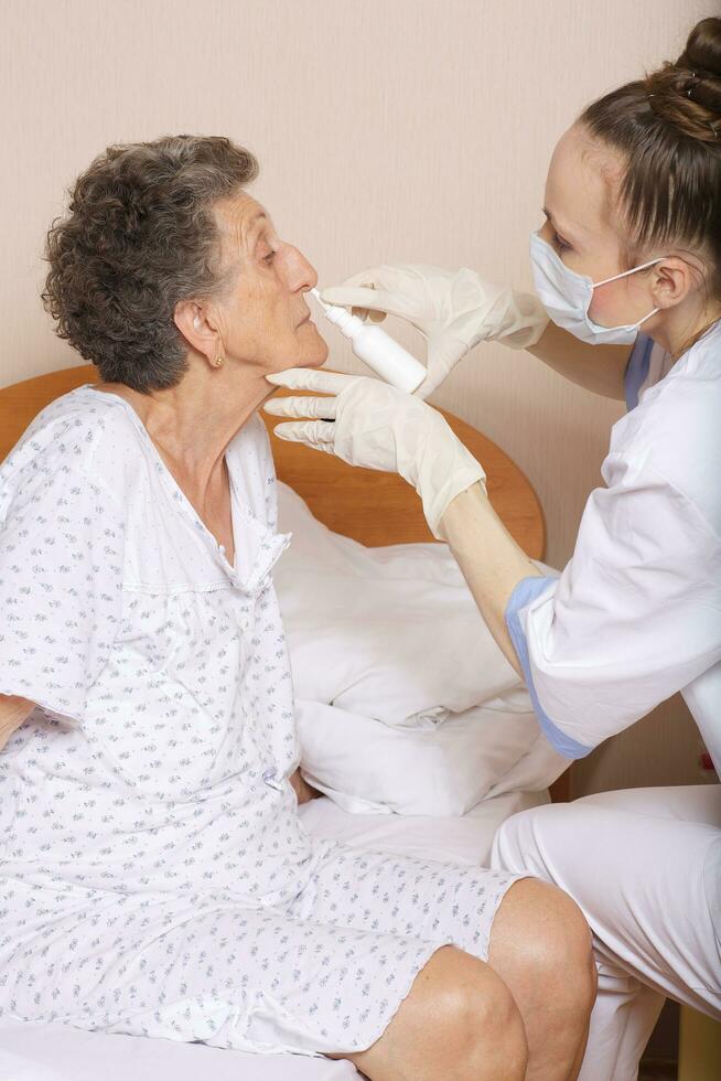 Geriatrician visits a senior woman photo