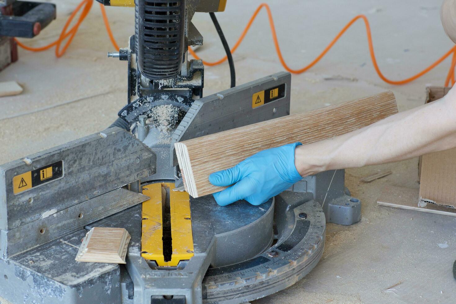 Woman wants to cut a piece of plinth. photo