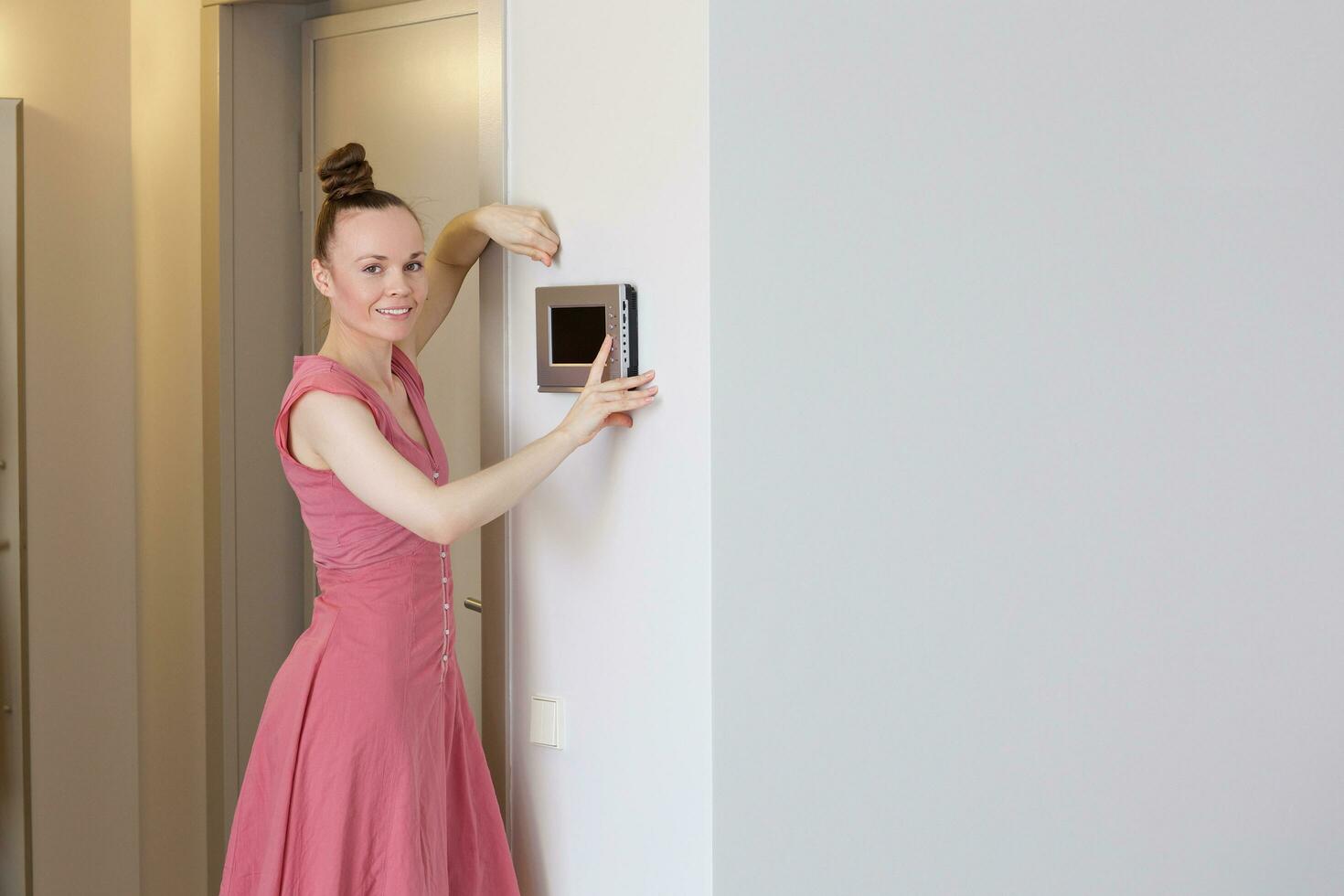 Young lady and intercommunication device. photo