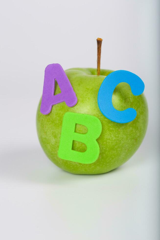 Apple and A,B,C letters attached to it. Closeup photo