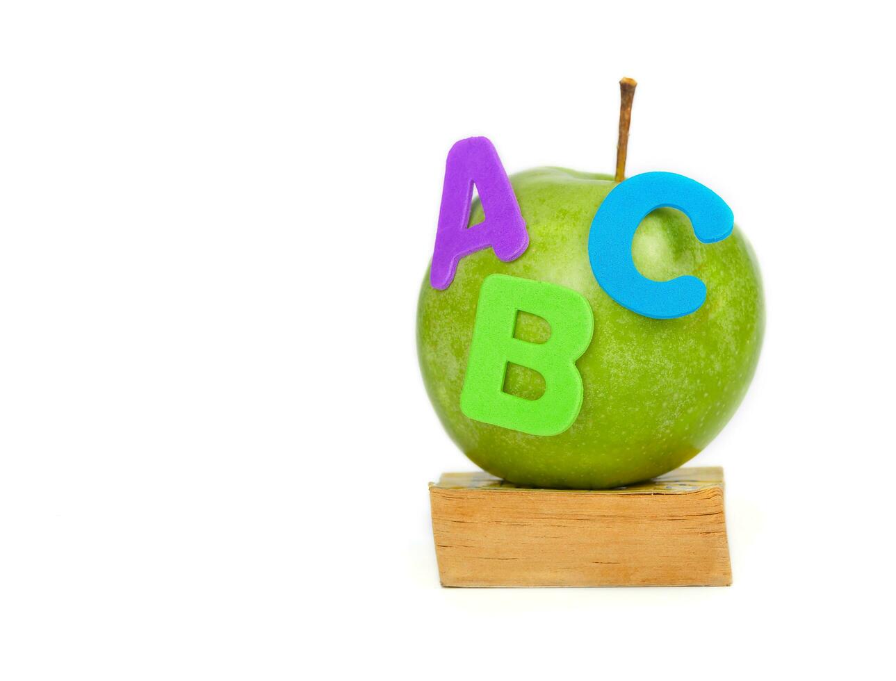 Apple and small book. Closeup photo