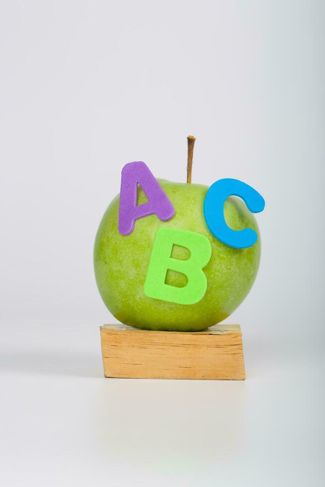 Apple and small book. Closeup photo