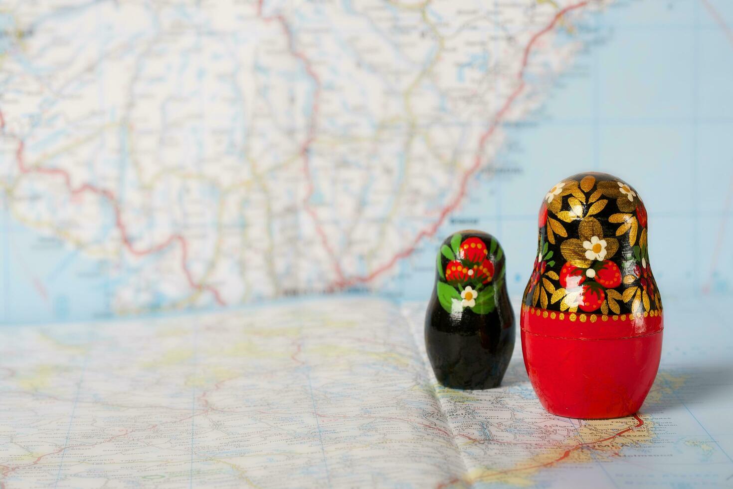 Russian matryoshka in khokhloma style on a map. Closeup photo