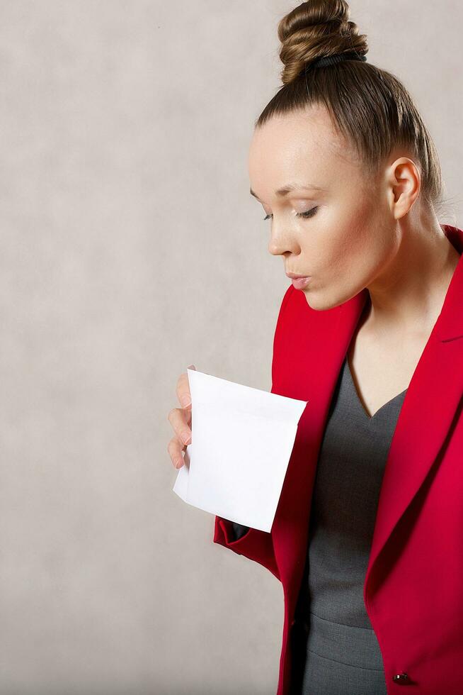 Young caucasian lady  keeps an envelope. Closeup photo