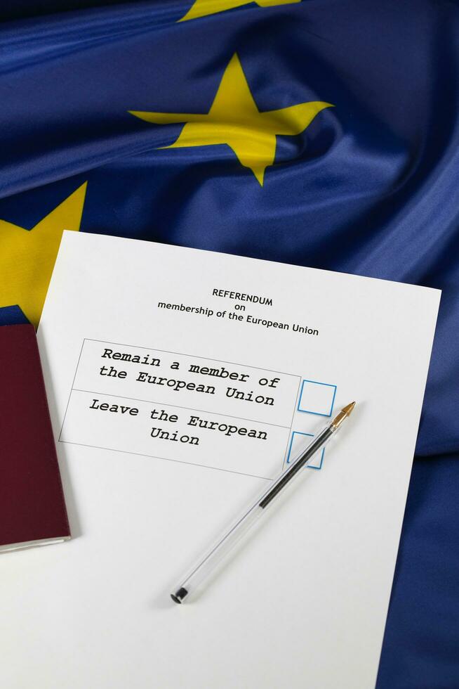 EU Referendum ballot paper, black pen, and passport on the table. photo