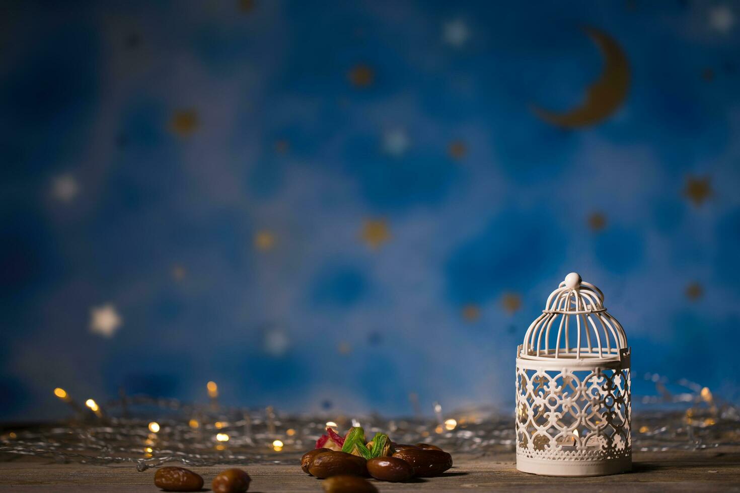 Dates and candle holder on a wooden surface. photo